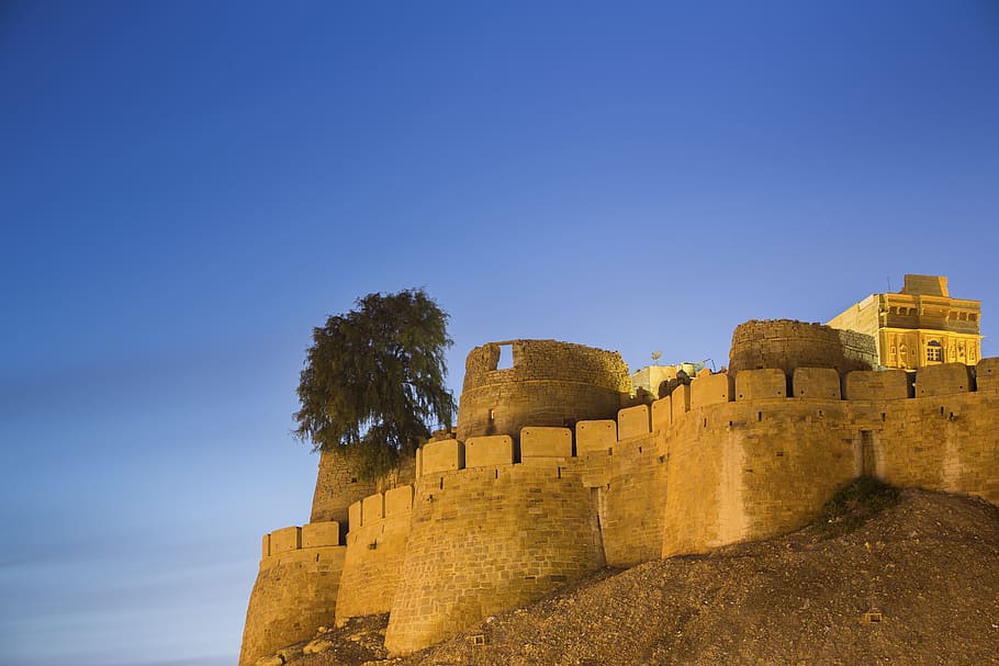 brown concrete castle near tree, brick fort under clear blue sky during daytime HD wallpaper