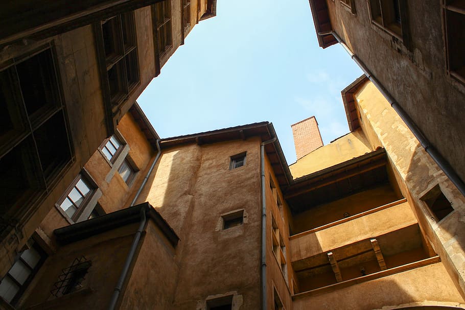 low angle photo of brown concrete building under blue sky during daytime, low angle view photography of brown buildings HD wallpaper