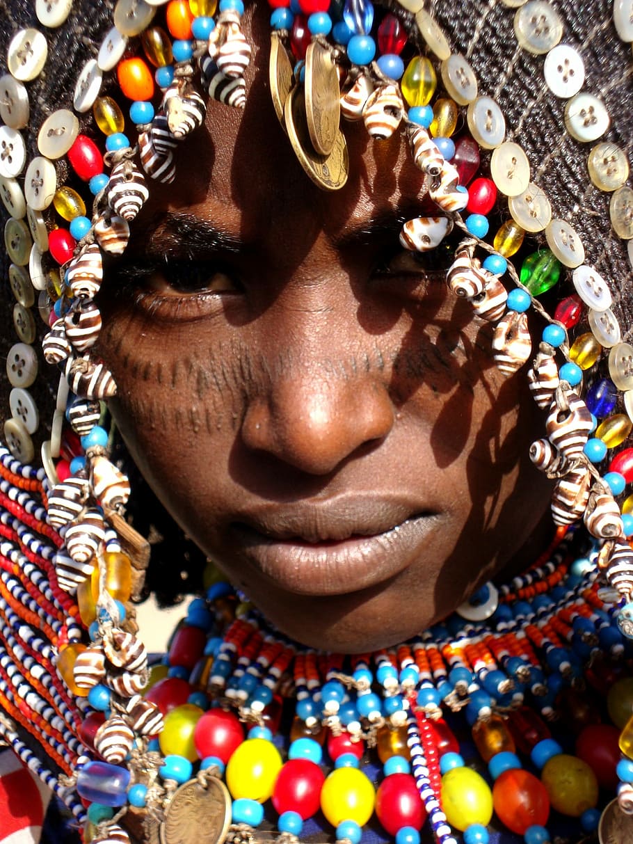 person wearing traditional headdress, beaded, hood, africa, african face