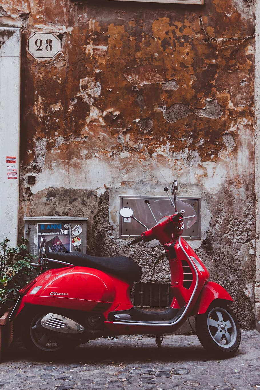 red motor scooter parked near wall, vespa, fun, cult, vehicle