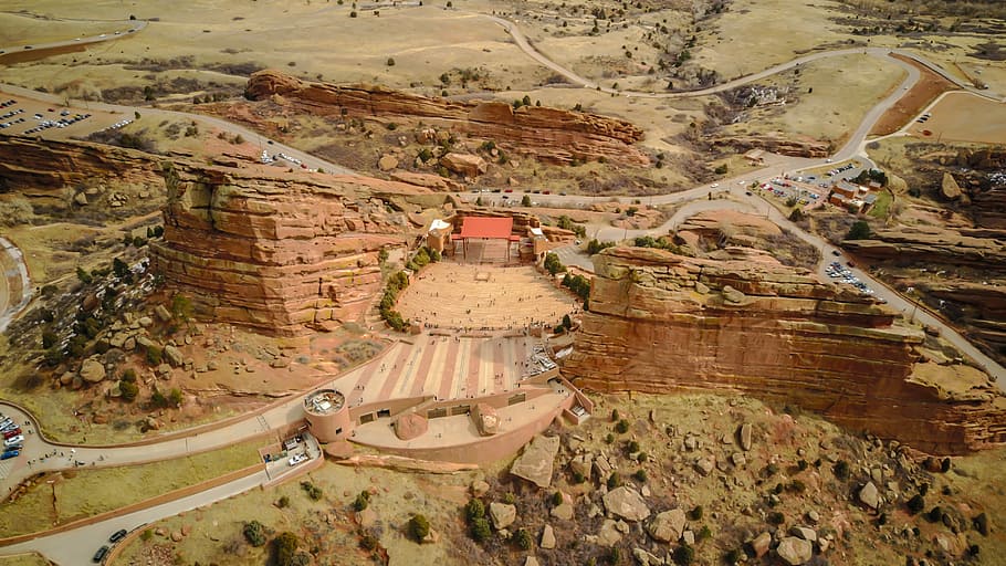 aerial photography of building in between mountains, bird's-eye view photography of rock formations HD wallpaper