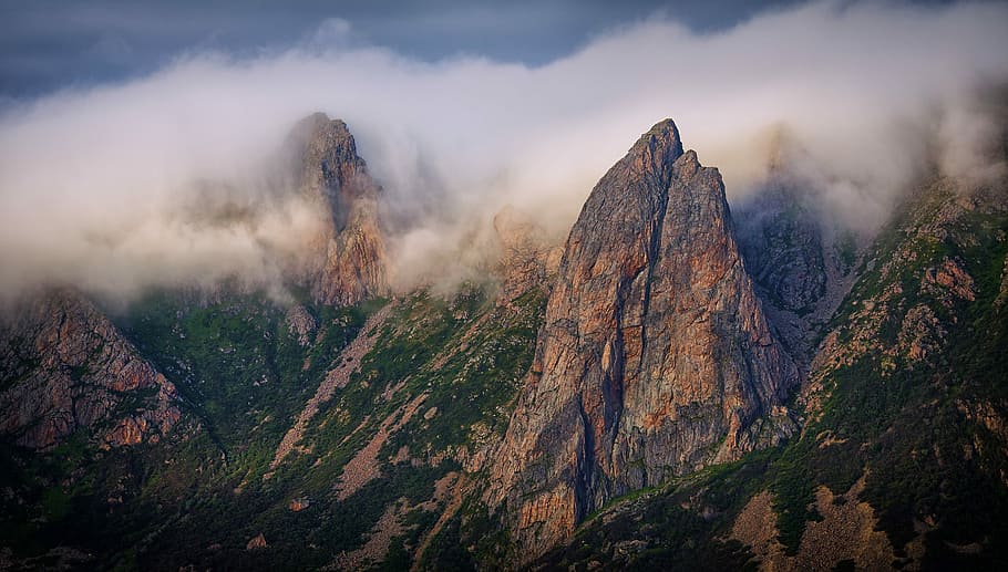 sea of clouds surrounding mountains, aerial view of rock cliffs HD wallpaper