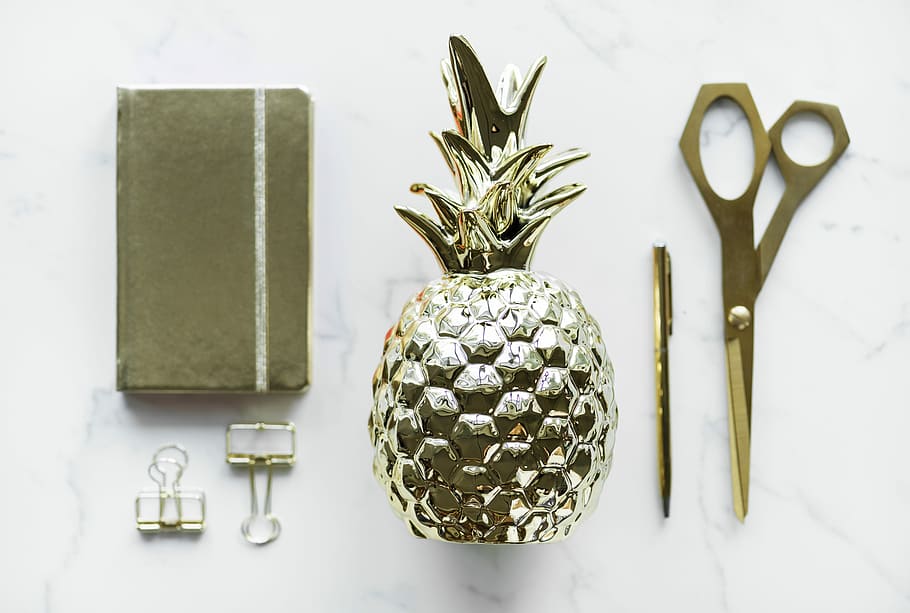 gold pineapple decor beside pen and scissors, flat lay, notebook HD wallpaper