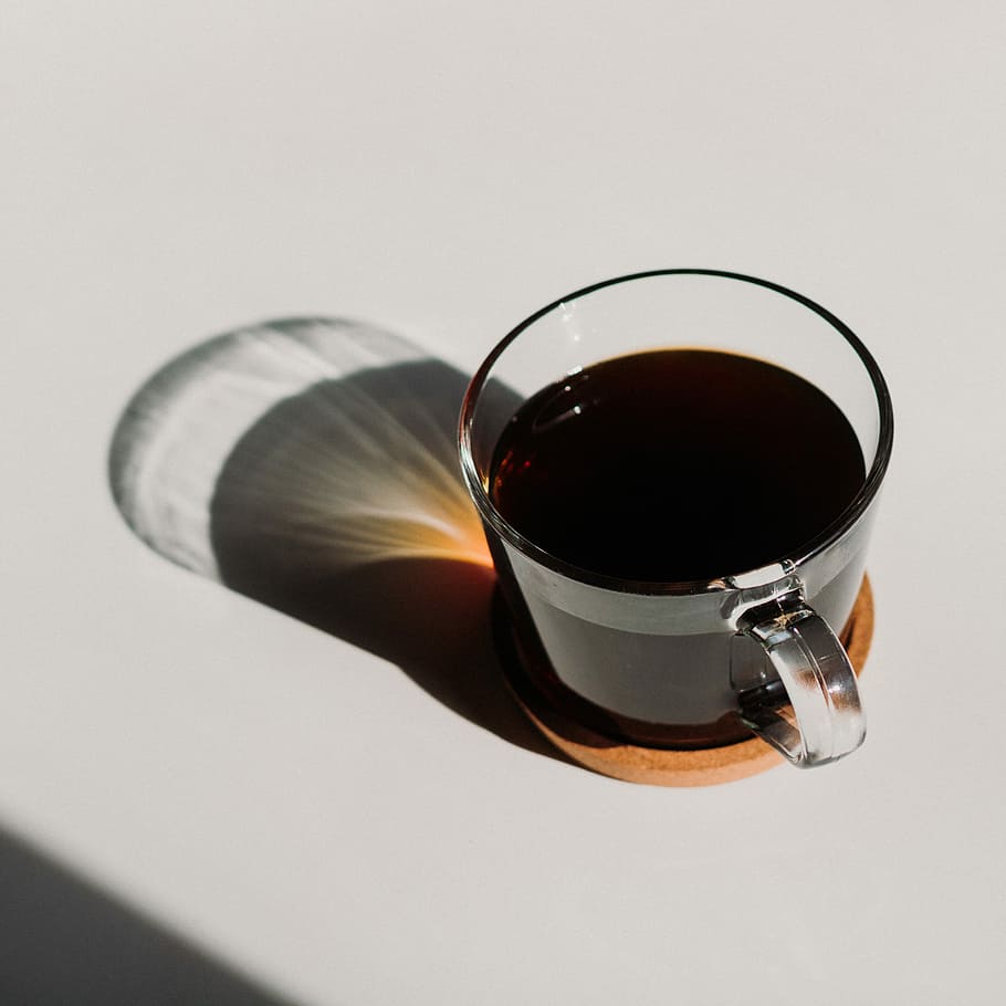 clear glass mug filled with brown liquid, almost full clear mug on white surface HD wallpaper