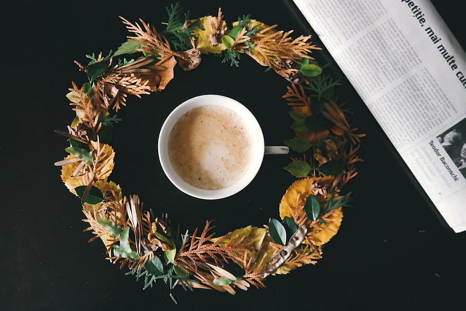 white ceramic teacup in yellow and green flower wreath on black surface photo HD wallpaper