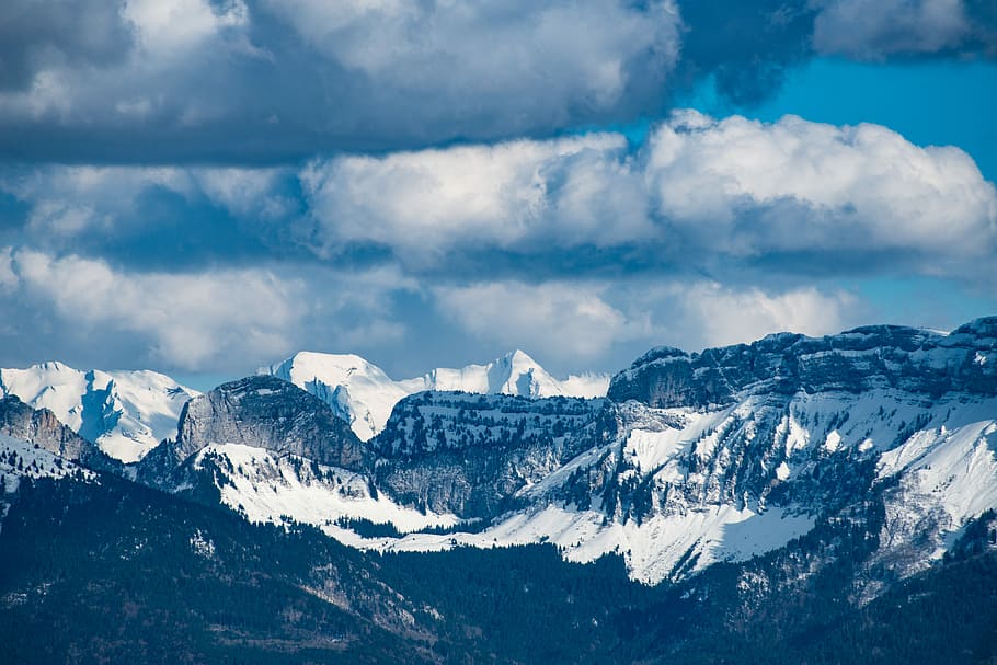 landscape photography of mountain during winter, black mountain covered by snow under white skies at daytime HD wallpaper