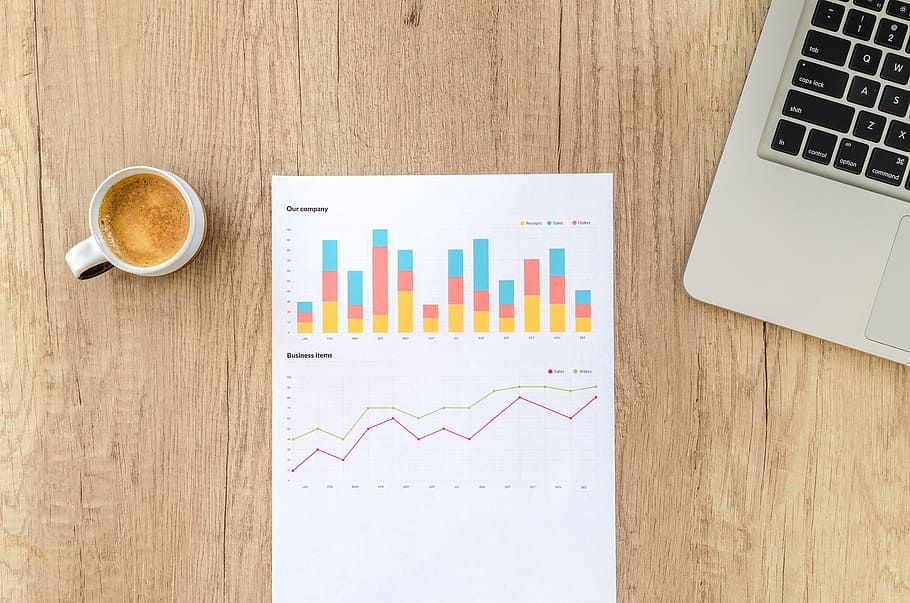 latte in cup near printer paper on wooden surface, chart, graph