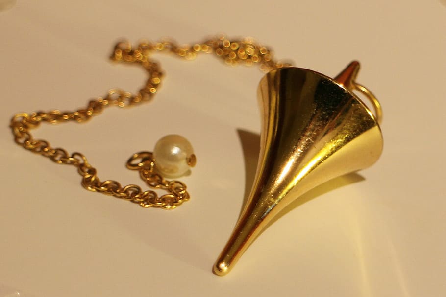 gold-colored pendant necklace on white surface, pendulum, commute HD wallpaper