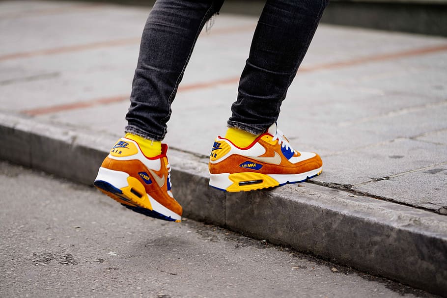 person wearing pair of orange-and-white Nike Air Max low-top shoes, person wearing yellow-white-and-orange Nike Air Max 90 shoes, HD wallpaper