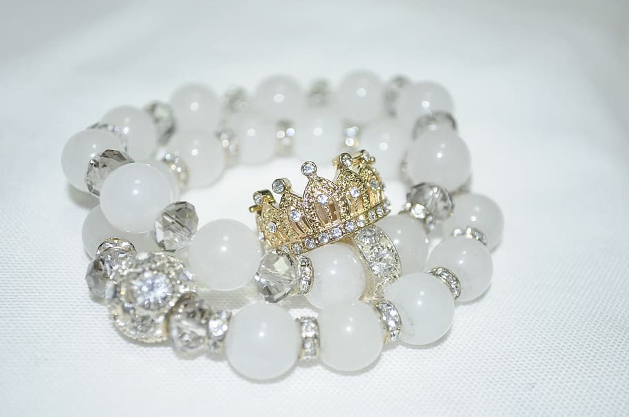 white and diamond studded beaded braceleton white surface, accessory