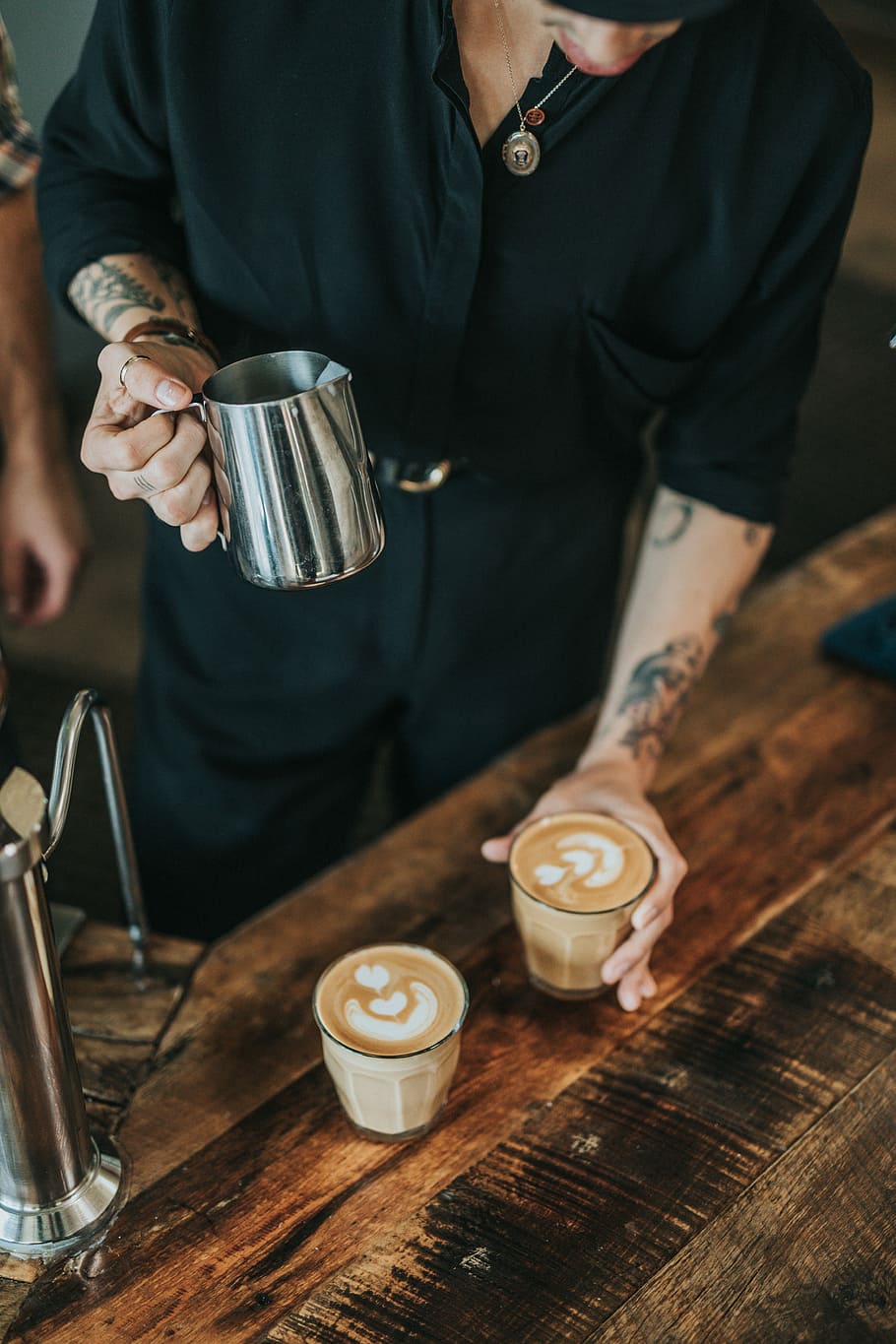 man pouring coffee in glass cups, person holding silver milk pitcher HD wallpaper