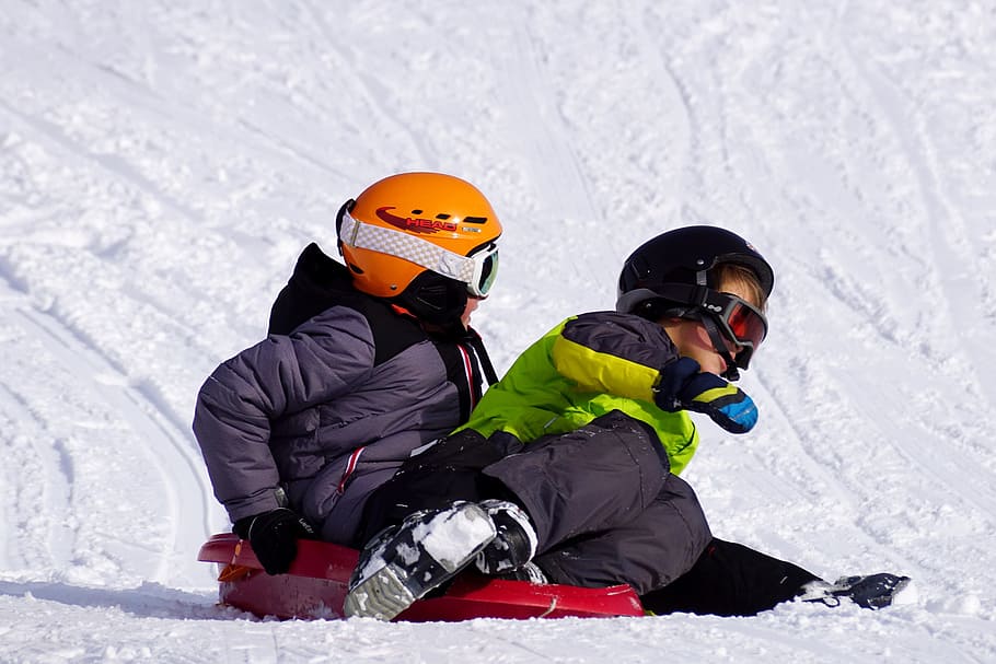 boy and girl on red sled, snow, winter, cold, ice, skiers, sport HD wallpaper