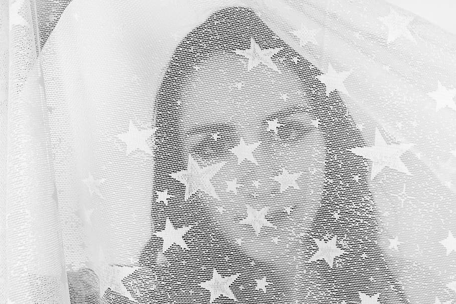 grayscale photography of woman's face covered with star print textile HD wallpaper