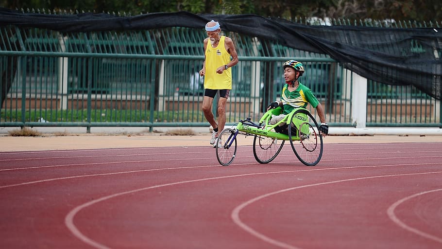man using green wheelchair for walking, man wearing yellow tank top jogging on track in field HD wallpaper