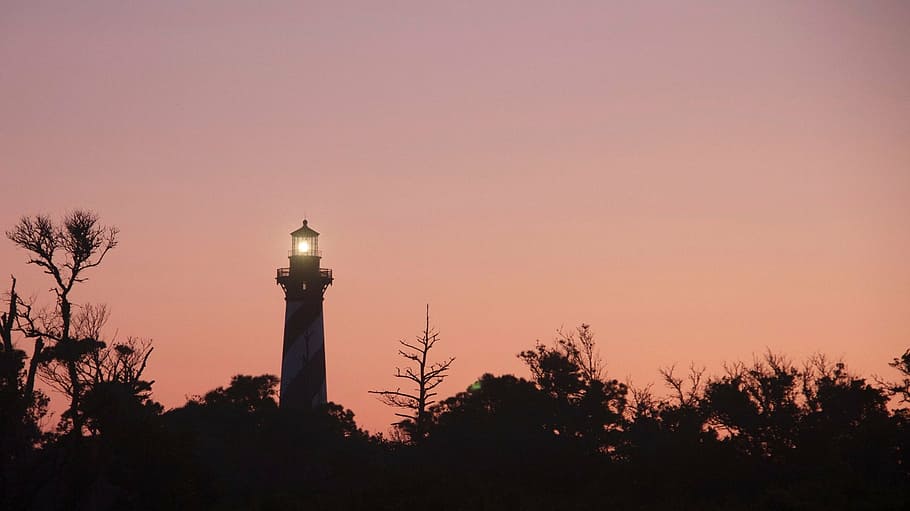 lighthouse, sunset, evening, silhouettes, sea, trees, ocean HD wallpaper