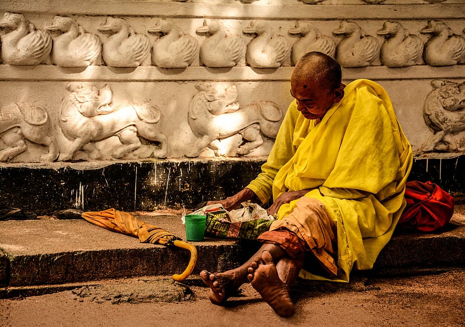 monk sitting near brown umbrella, people, homeless, male, street