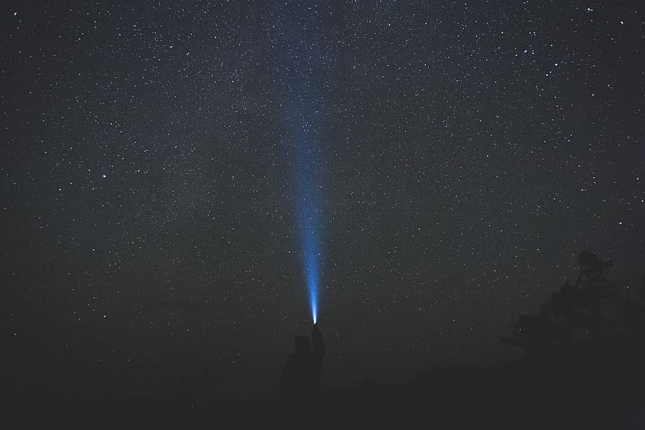 man holding turned on flashlight outdoor during nighttime, person using flashlight at night HD wallpaper