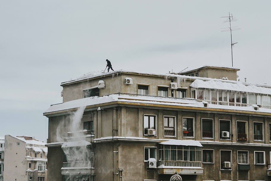 man on brown concrete building, residence house covered snow HD wallpaper