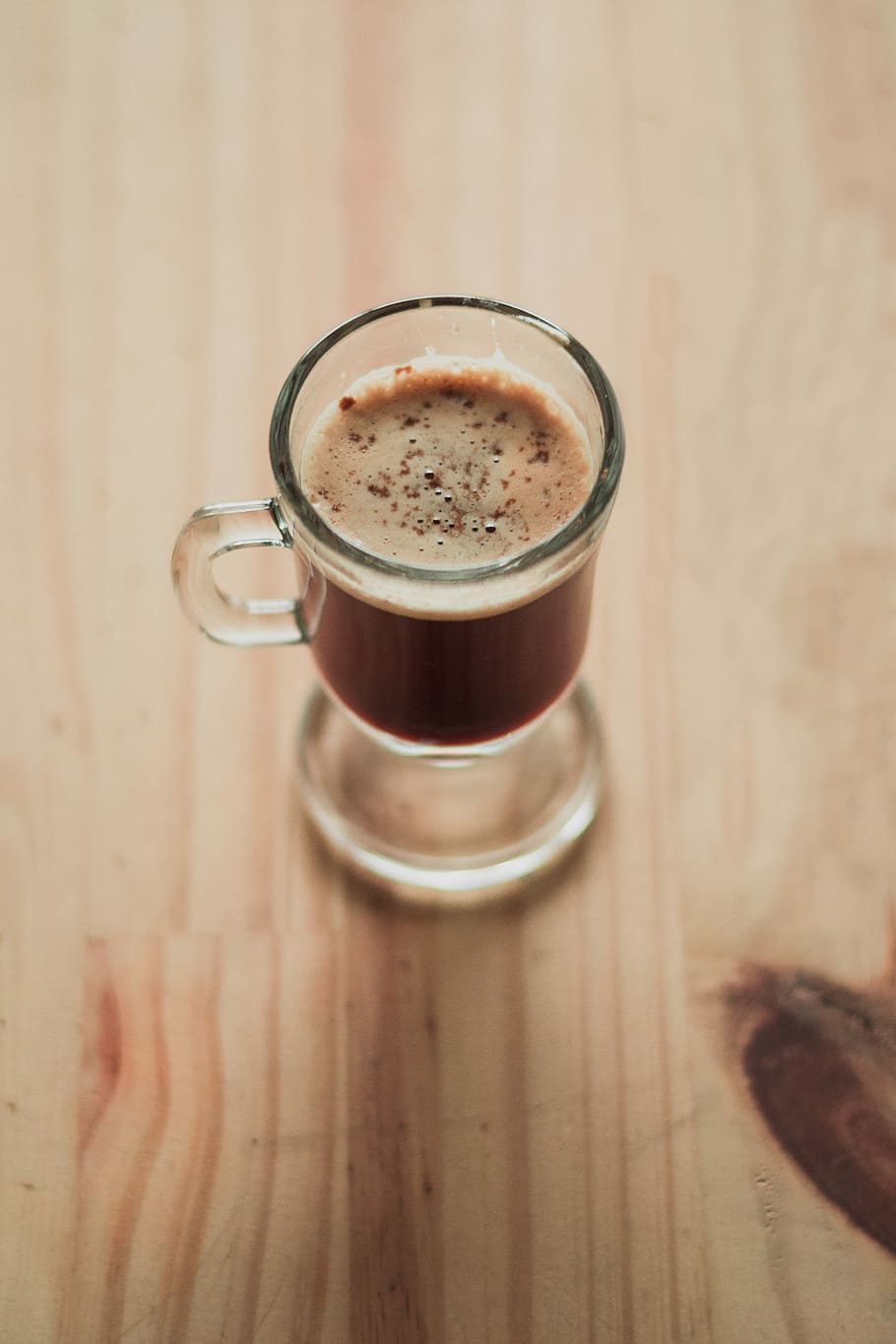 brown liquid-filled clear glass cup, clear footed glass filled with capucino on desk HD wallpaper