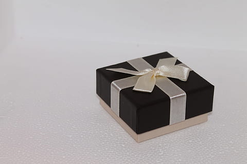 square black and brown bow accent gift box on white surface HD wallpaper