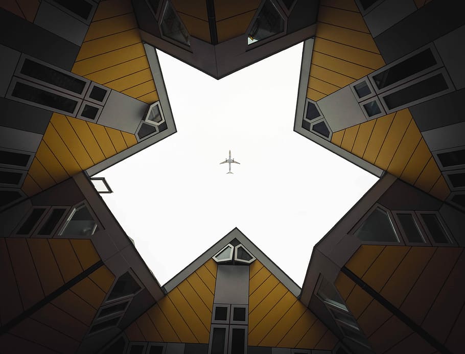 HD wallpaper: worm's eye view of building showing airplane in the sky ...