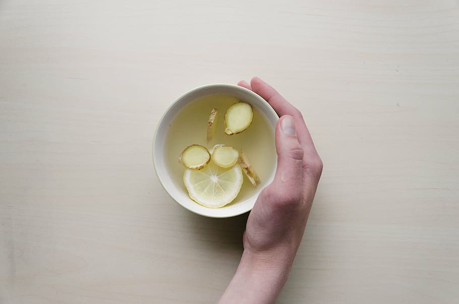 person holding white ceramic bowl with sliced lemon, human HD wallpaper