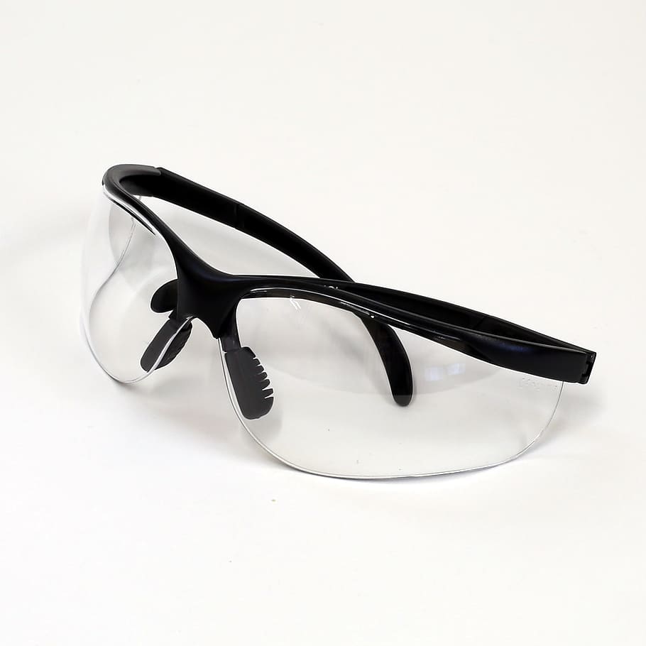 black framed shield glasses on white surface, safety glasses