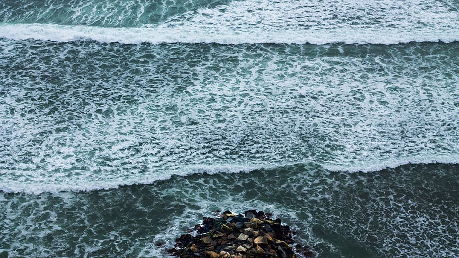 aerial view of ocean waves, bird's eye photography of rocks on shore with ocean waves HD wallpaper