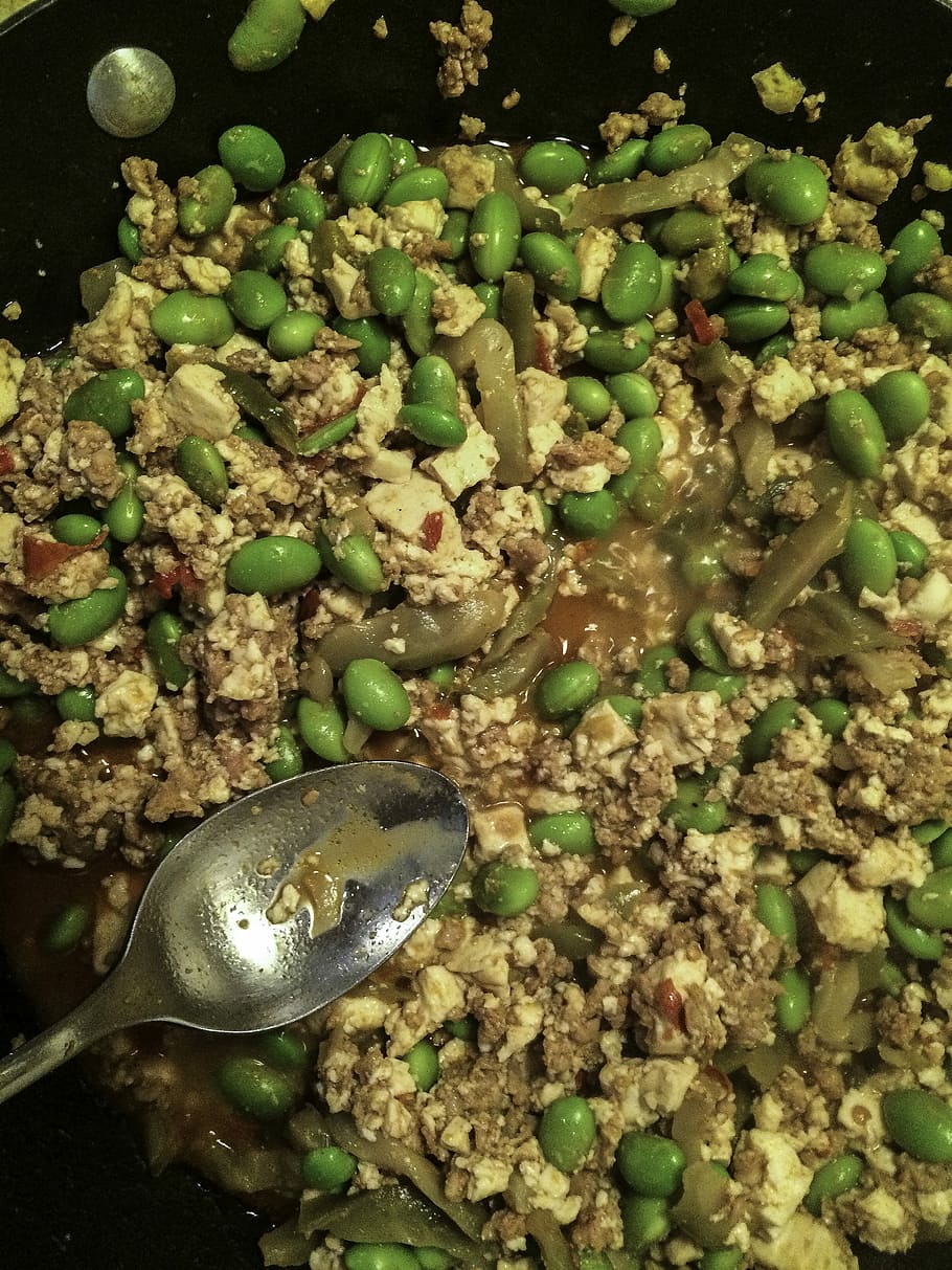 Beans, tofu, and pork being stir fried, public domain, spoon