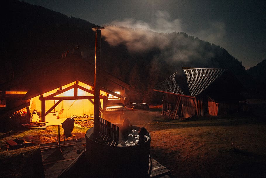 person on sauna bath during nighttime, two people in hot tub photo during nighttime HD wallpaper