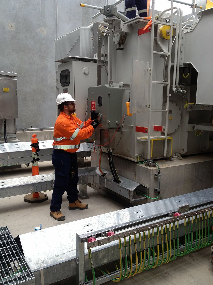 man touching industrial machine, electrical services, hv testing HD wallpaper