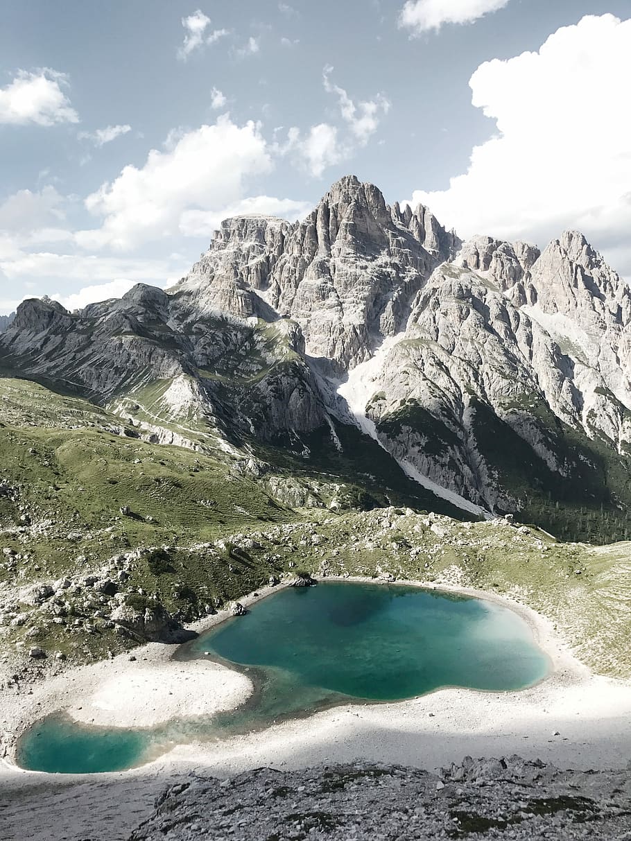 gray rocky mountain under cloudy sky during daytime, lake near mountain bird's eye photography HD wallpaper