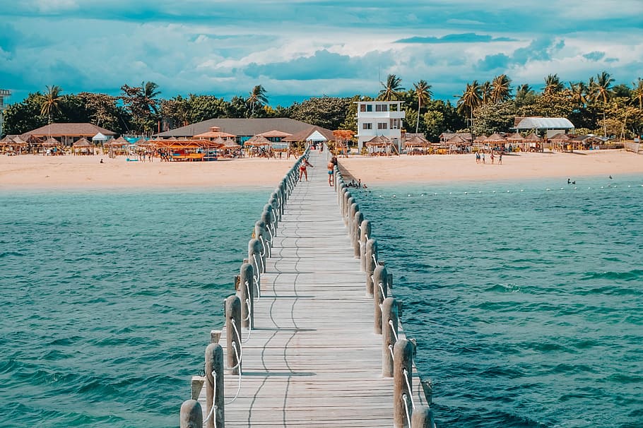 photo of brown wooden dock towards beach, photo of boardwalk between body of water HD wallpaper