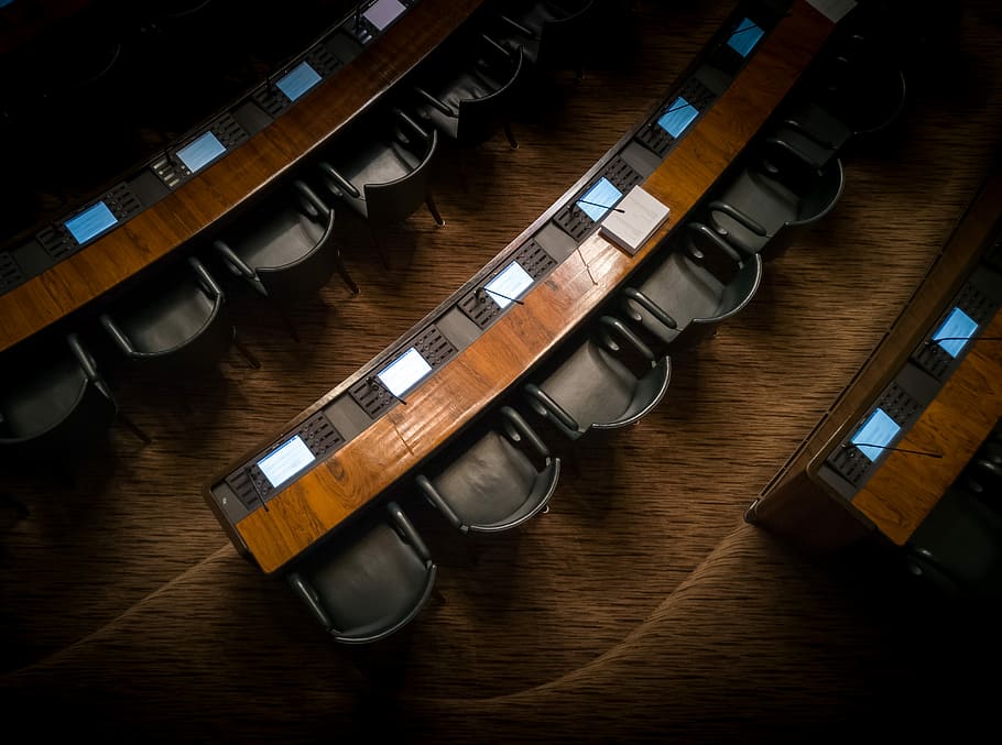 low light photography of armchairs in front of desk, auditorium room HD wallpaper