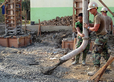 two man holding white tube in front of cement, working, workers HD wallpaper