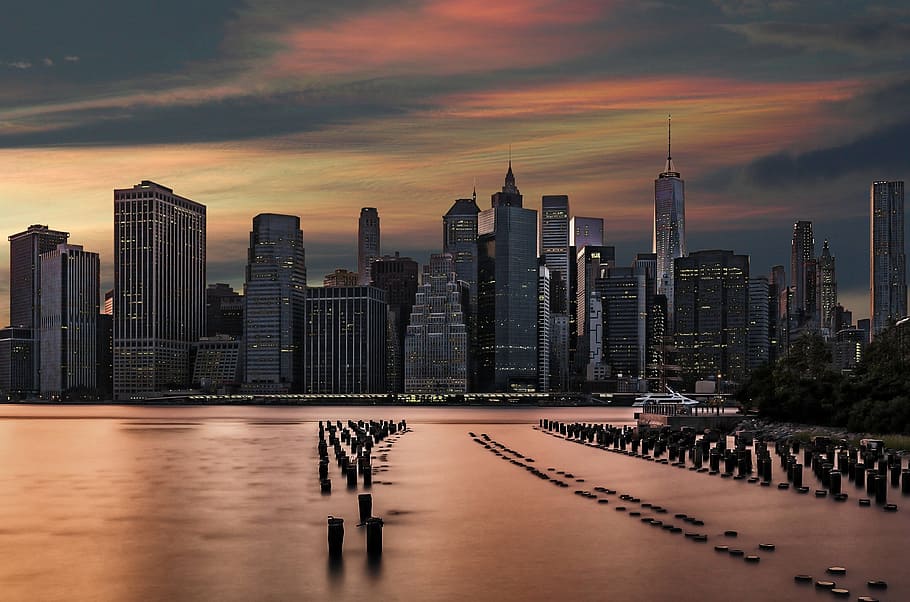 high-rise buildings near body of water taken during daytime HD wallpaper