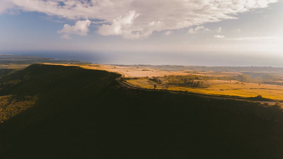 landscape photo of near tall tree and yellow grass field at daytime, aerial view photography of highway under cloudy sky during daytime HD wallpaper