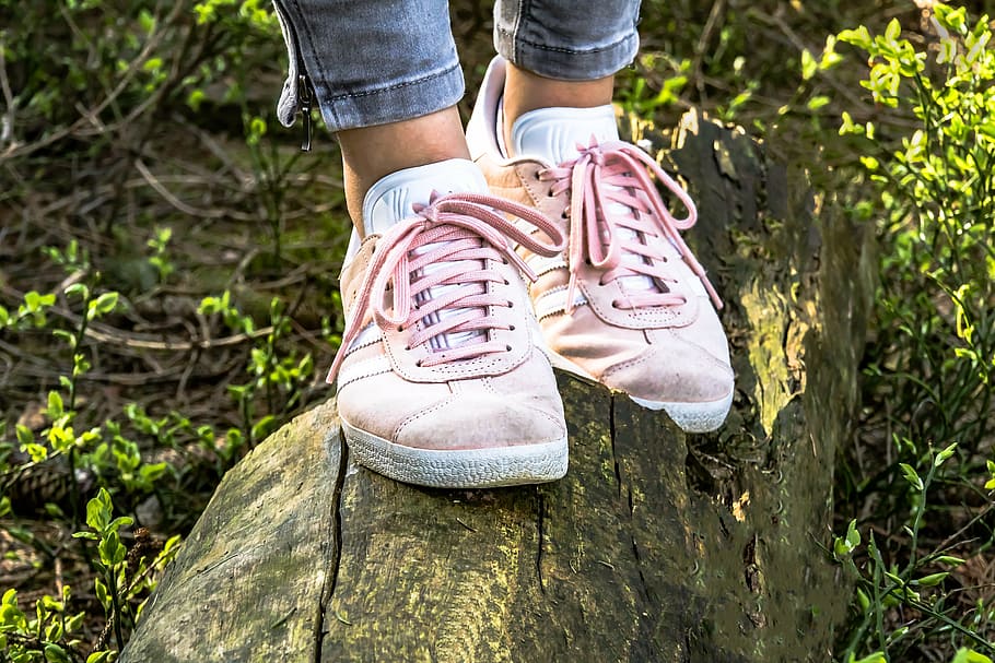 person wearing pair of pink low-top sneakers, shoes, girls shoes
