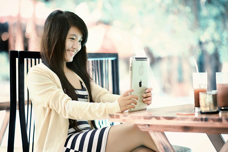 woman wearing white and black striped dress, ipad, girl, tablet