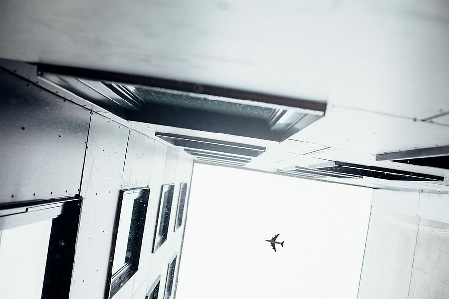 low angle and architectural photography of buildings and airplane HD wallpaper