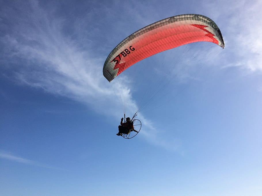 person paragliding under blue sky, person with red and white paracute HD wallpaper