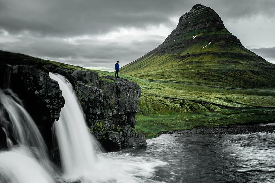 man standing near waterfalls at daytime, nature, landforms HD wallpaper