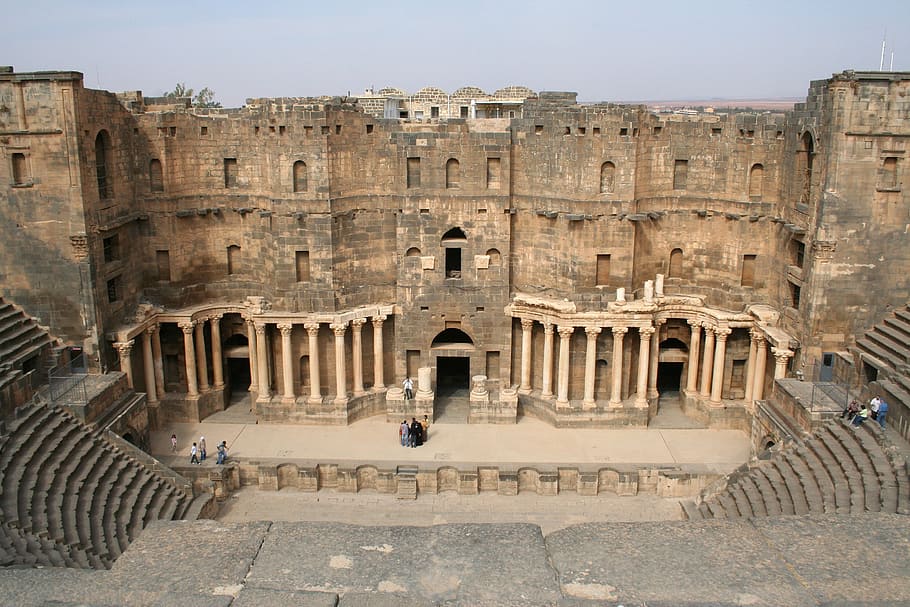 brown ruins under gray sky, syria, bosra, amphitheater, history