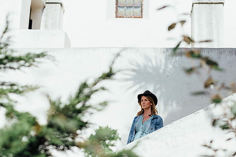 woman standing beside white wall during daytime, time Of Day HD wallpaper