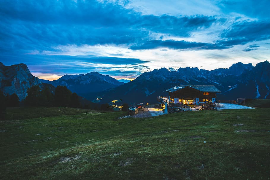 house near mountains under blue sky during sunset, panorama photography of brown house HD wallpaper