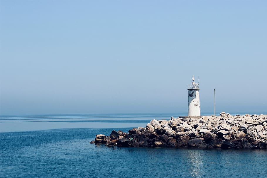 photograph of white lighthouse on rocks, white light tower, sea HD wallpaper