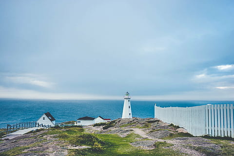 white lighthouse near wooden fence and body of water, beacon HD wallpaper