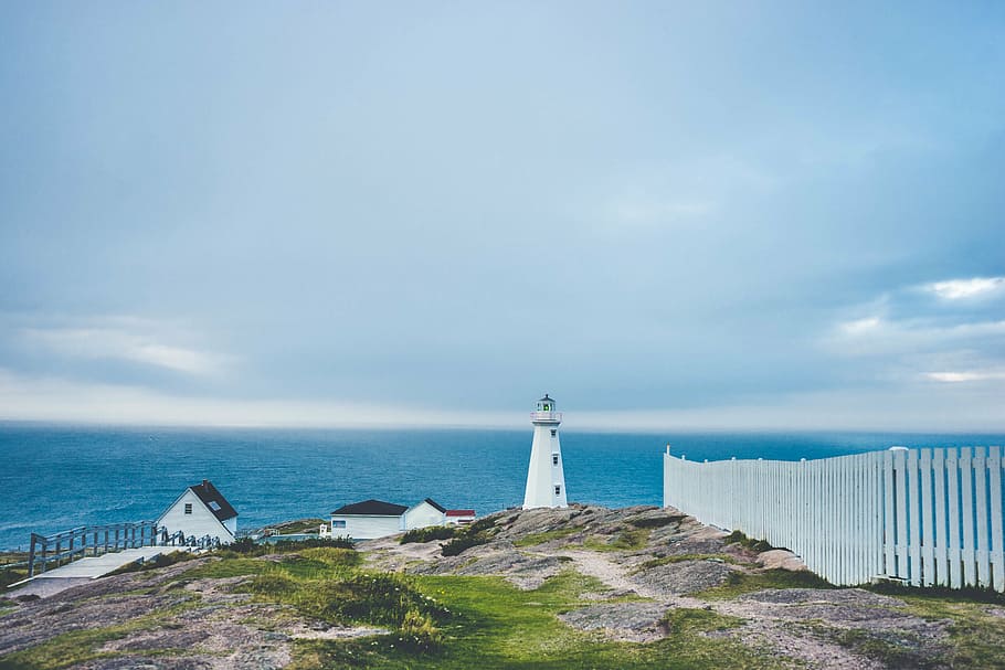 white lighthouse near wooden fence and body of water, beacon HD wallpaper