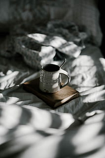 white enamel cup on brown book, white ceramic mug on brown wooden board HD wallpaper
