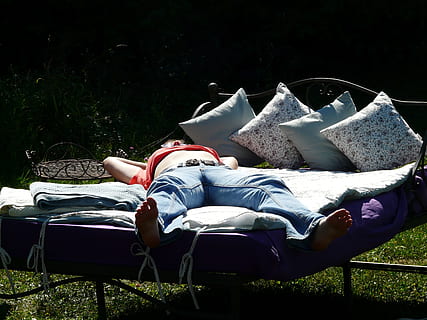 person wearing red shirt and washed blue jeans laying on bed HD wallpaper